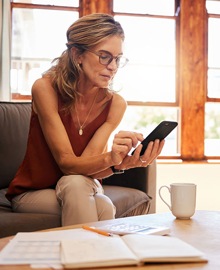 Woman using phone in living room