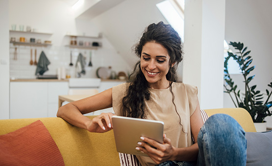 Woman using tablet in living room