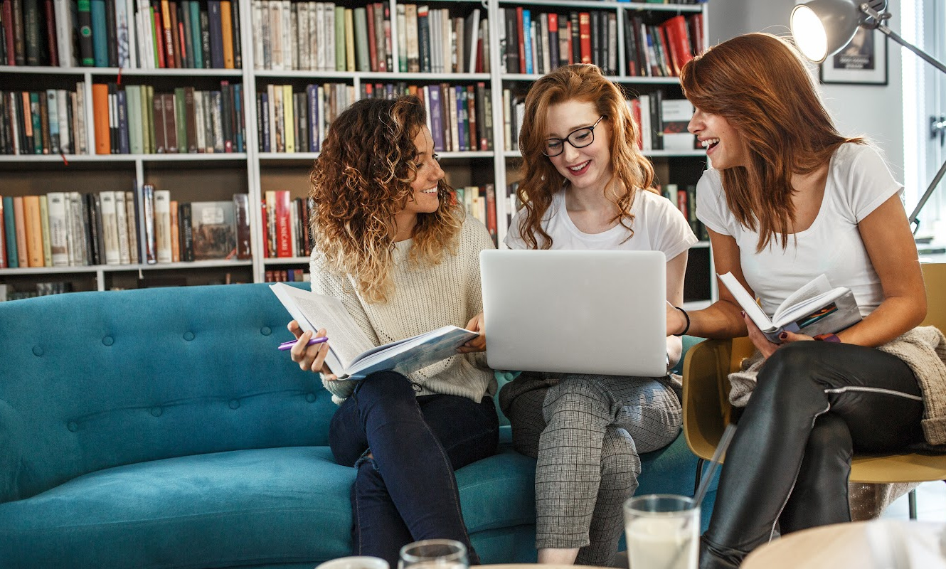 Three women looking at laptop