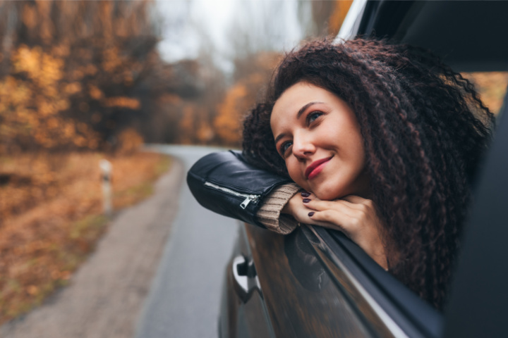 woman looking out car window