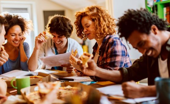 group of people eating pizza