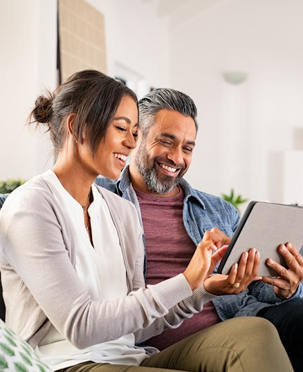 man and woman looking at tablet