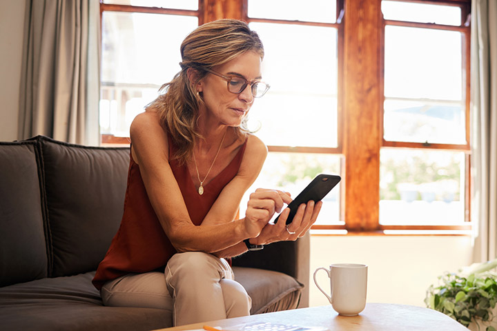 Woman using phone in living room