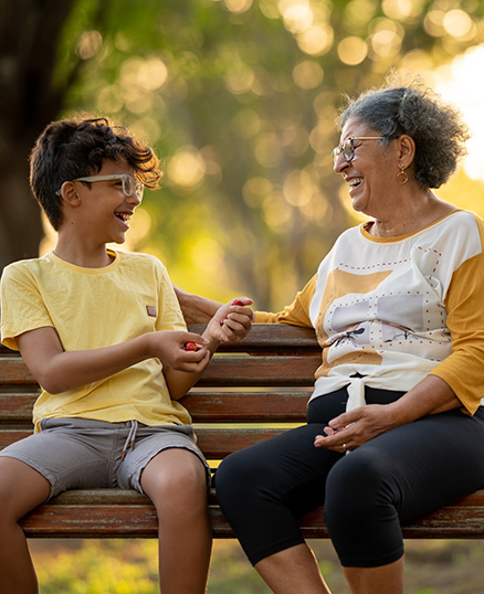 Grandmother and grandson talking on park bench