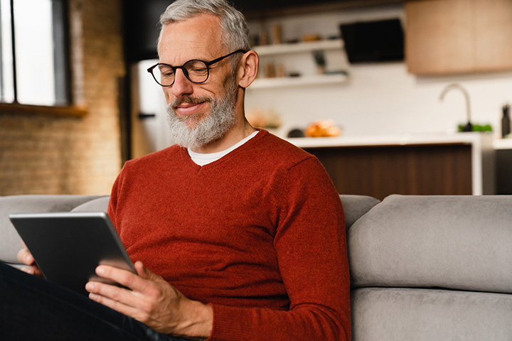 Man using tablet in living room