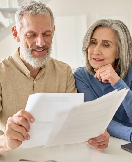 man and woman looking at bills