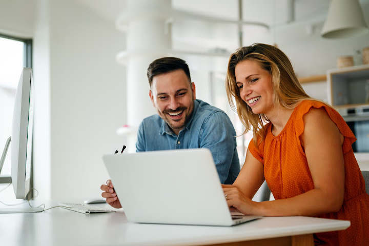 Couple at counter looking at laptop