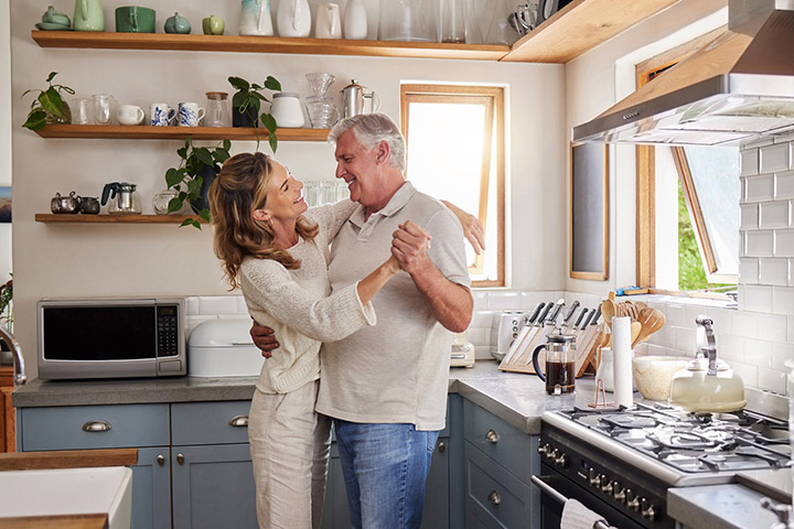 Senior couple dancing in kitchen