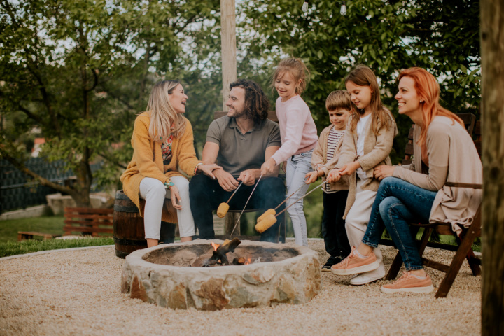 group roasting corn at a campfire