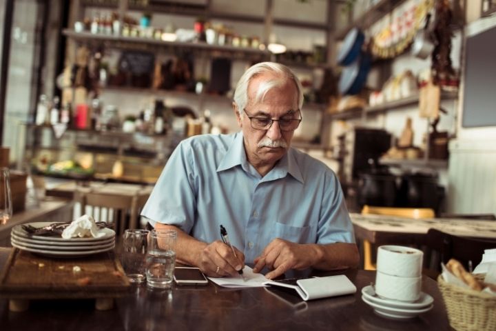 Male business owner writing