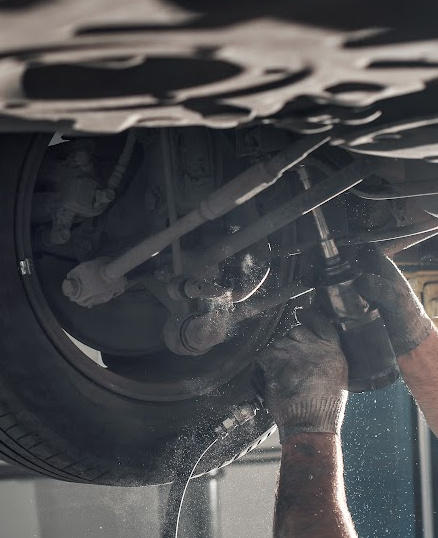 Hands working under a car