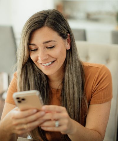 happy woman looking at cell phone