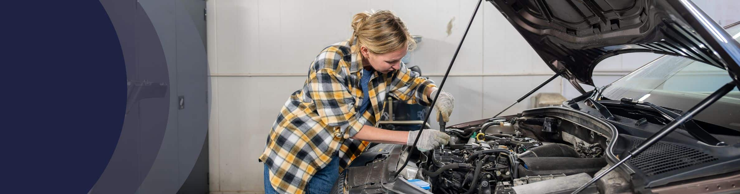 woman working on a car