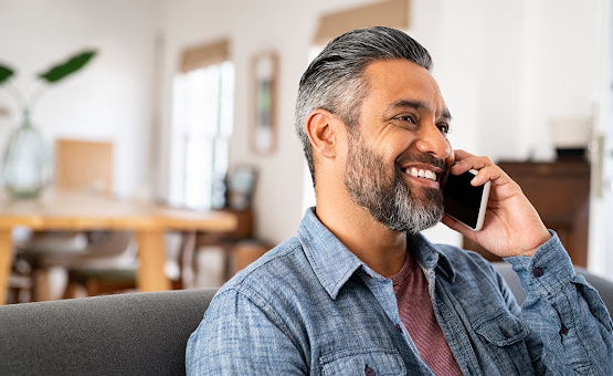 man talking on cell phone at home