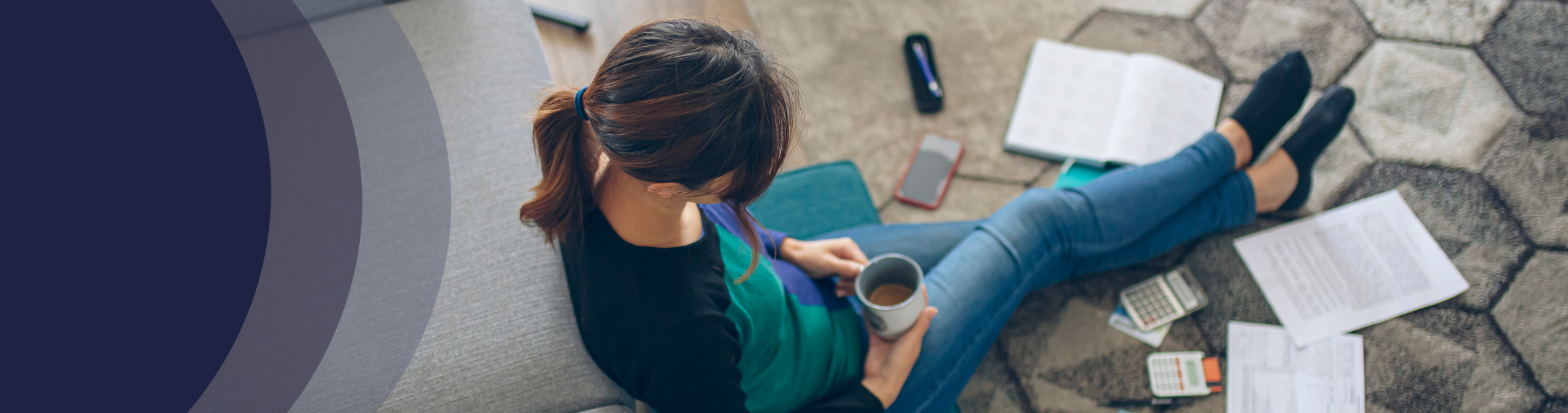 Lady sitting on the ground looking at documents