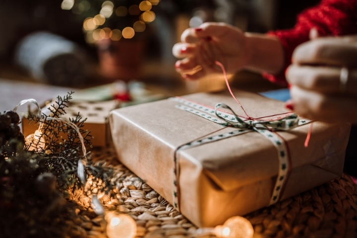 Hands wrapping a Christmas gift