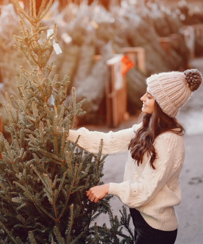 woman shopping for a Christmas tree