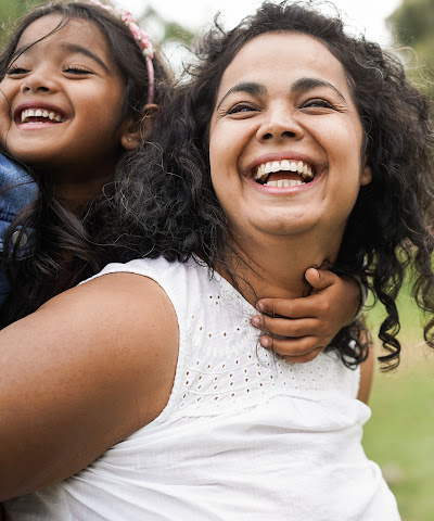 Happy mom with happy daughter on her back