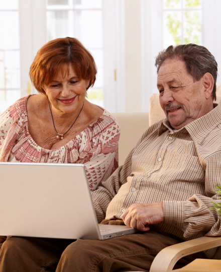 Elderly couple looking at a computer