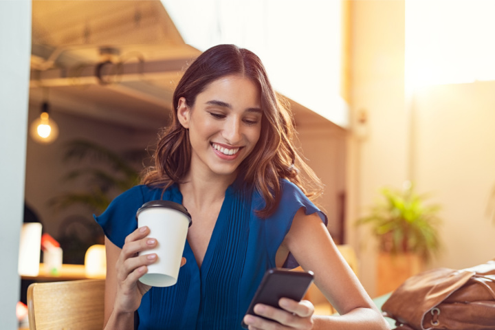 happy woman looking at cell phone