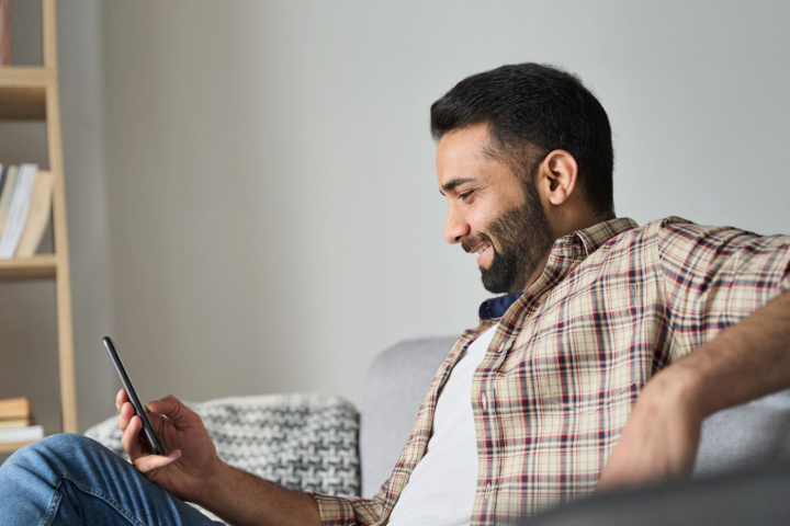 happy man looking at cell phone