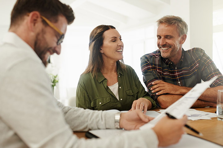 Mature couple talking to loan professional