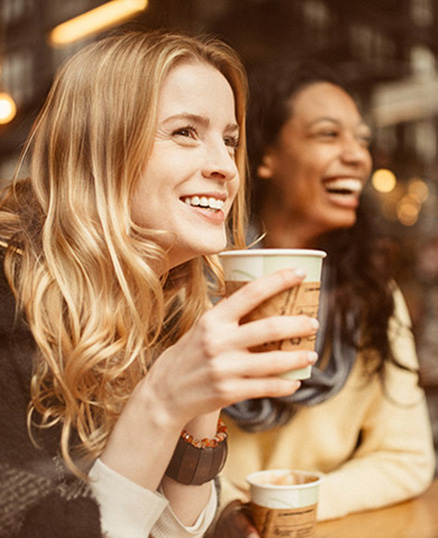 Two women drinking coffee in restaurant