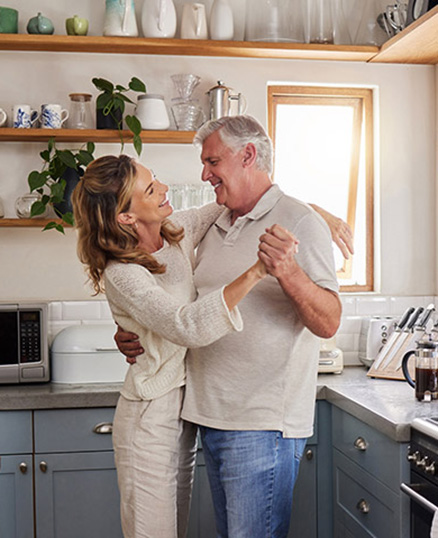 Senior couple dancing in kitchen