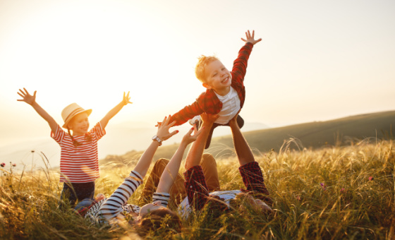 family playing in the grass