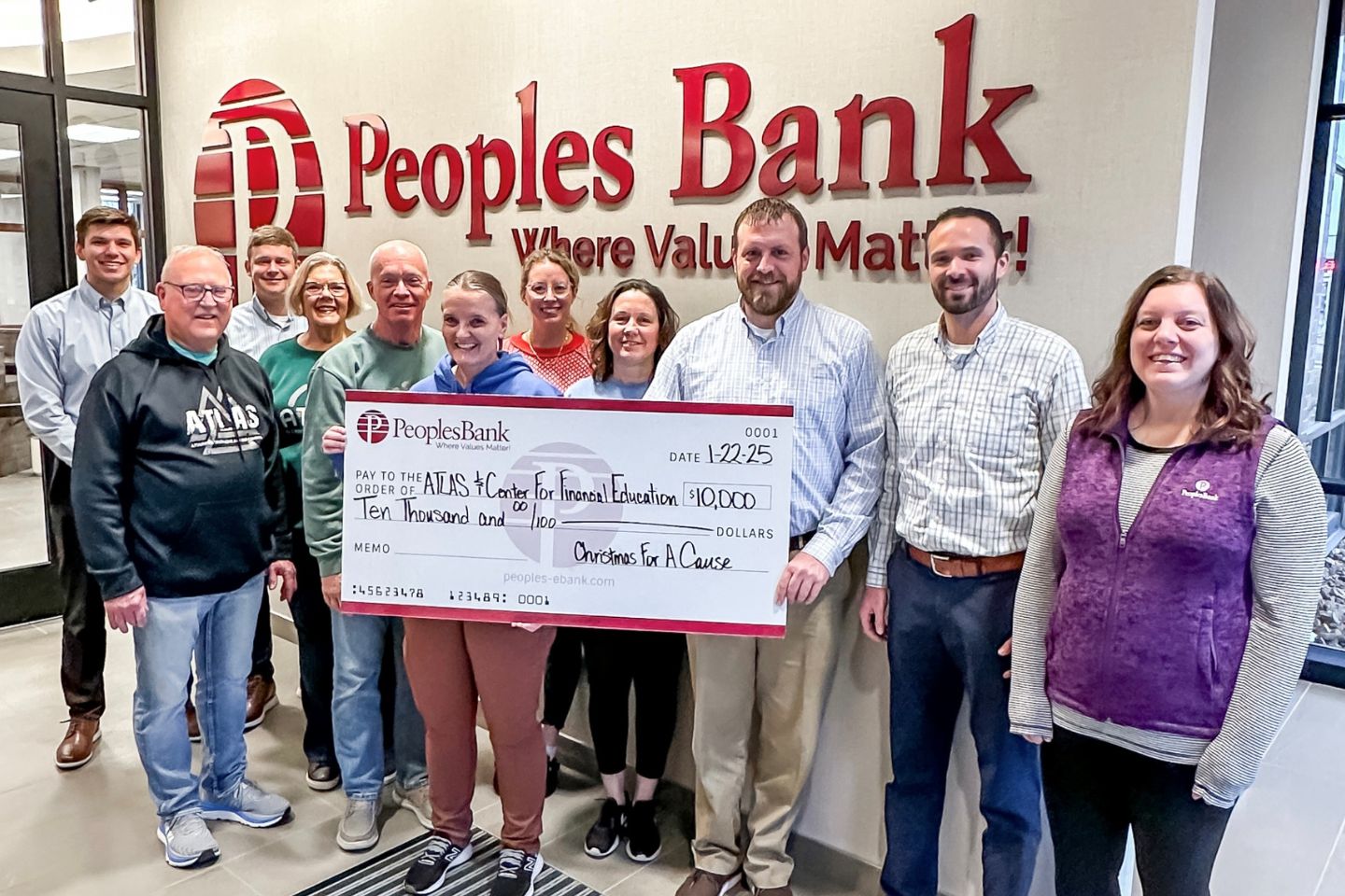 Peoples Bank and ATLAS employees with big Christmas For A Cause check