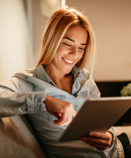 Woman using tablet in living room