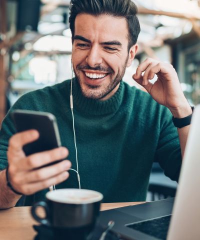 smiling man looking at cell phone