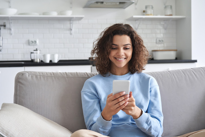 Woman looking at cell phone at home