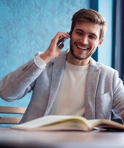 smiling man talking on cell phone